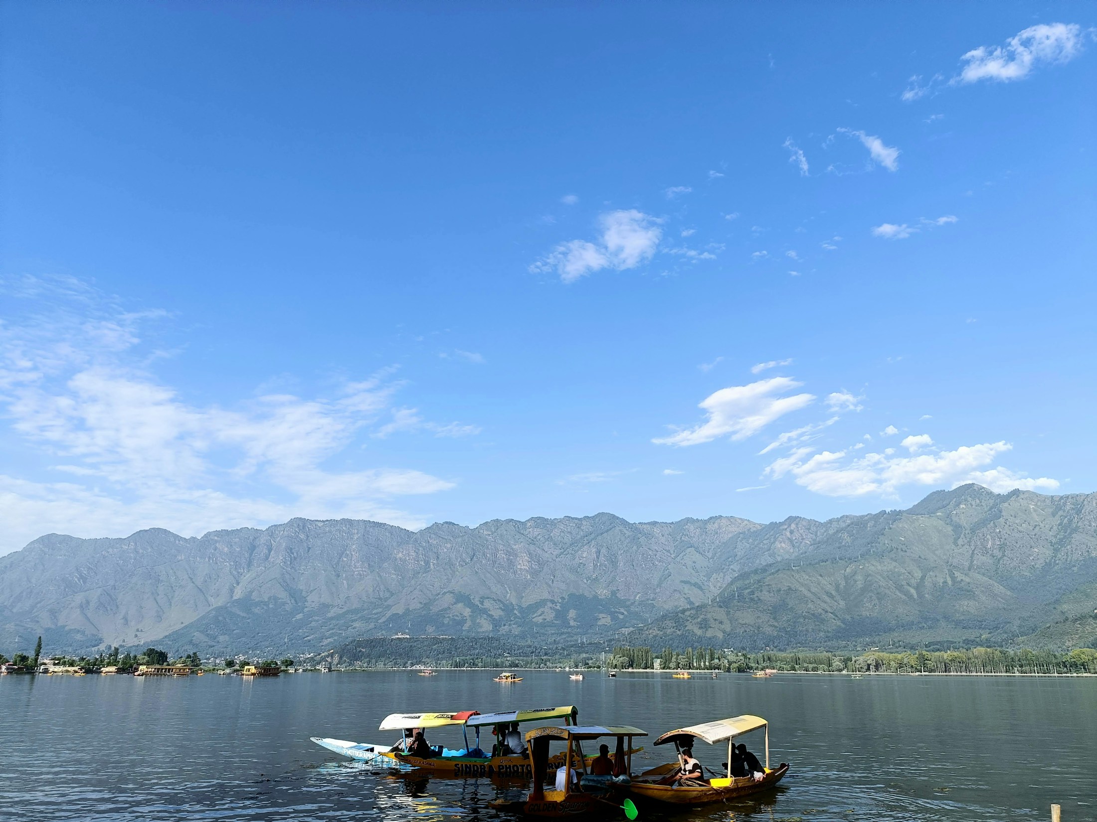 Shikaras on Dal Lake beneath the mountains of Kashmir